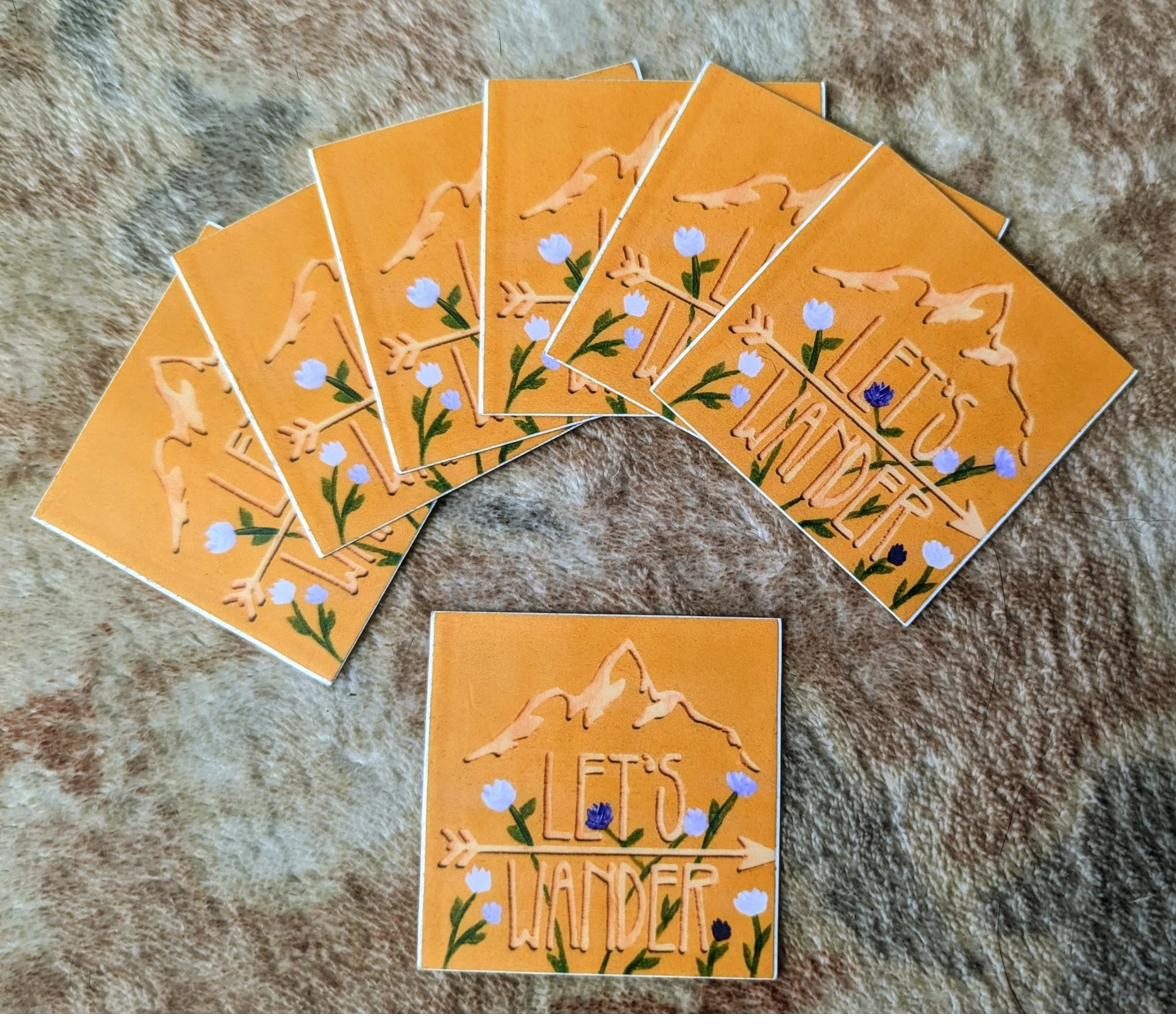 Hand painted Let's Wander stickers with mountain and flowers